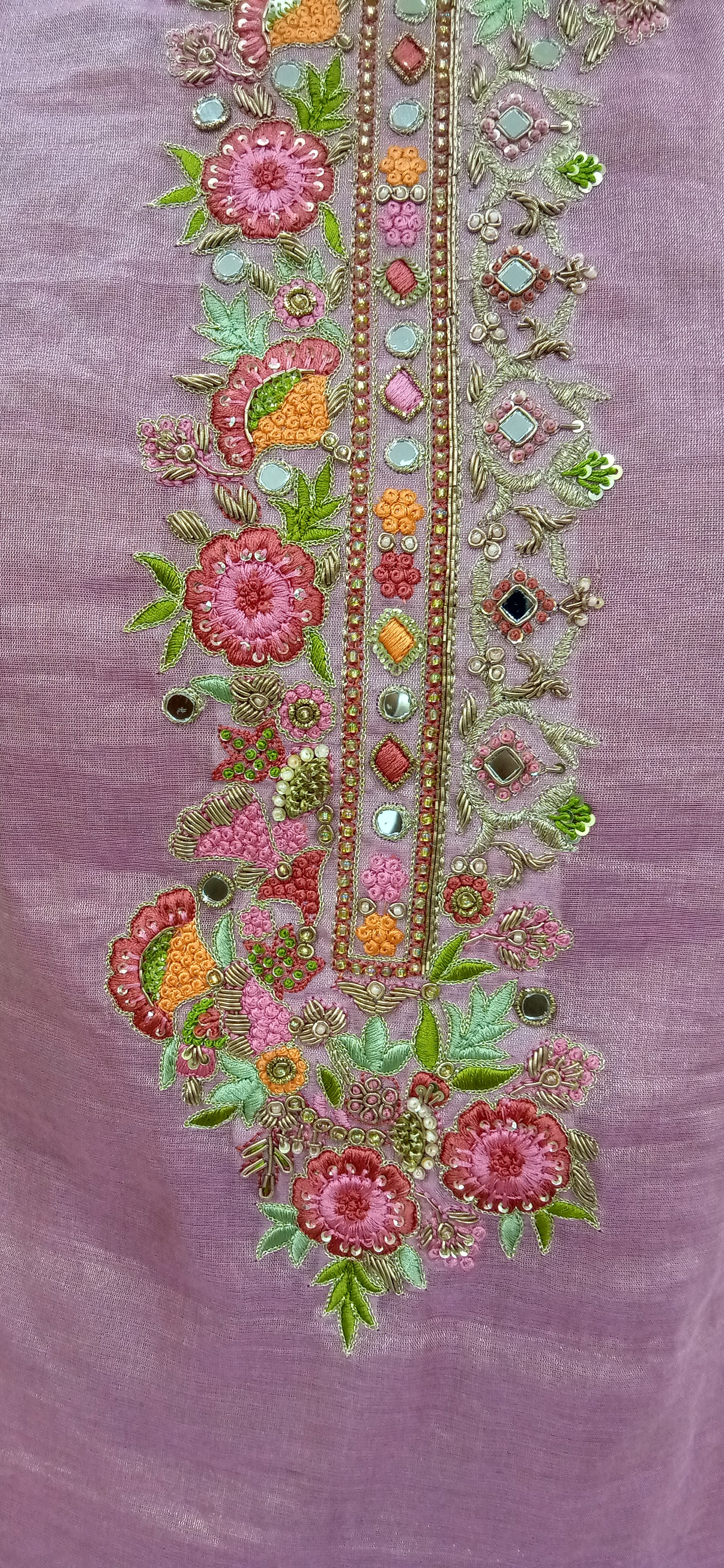 Decorative floral embroidery on a purple fabric background