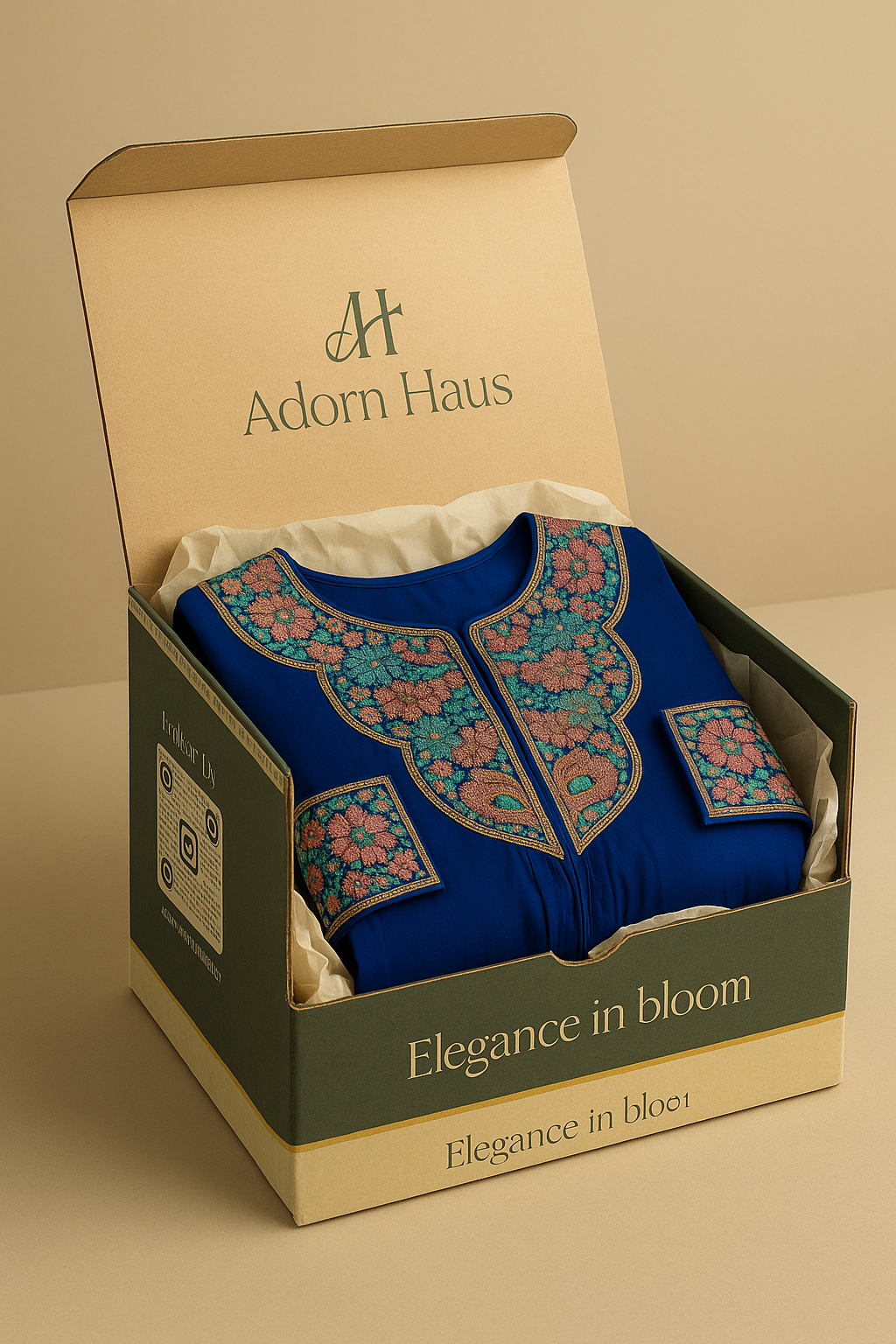 Blue embroidered garment in a 'Adorn Haus' box on a beige background