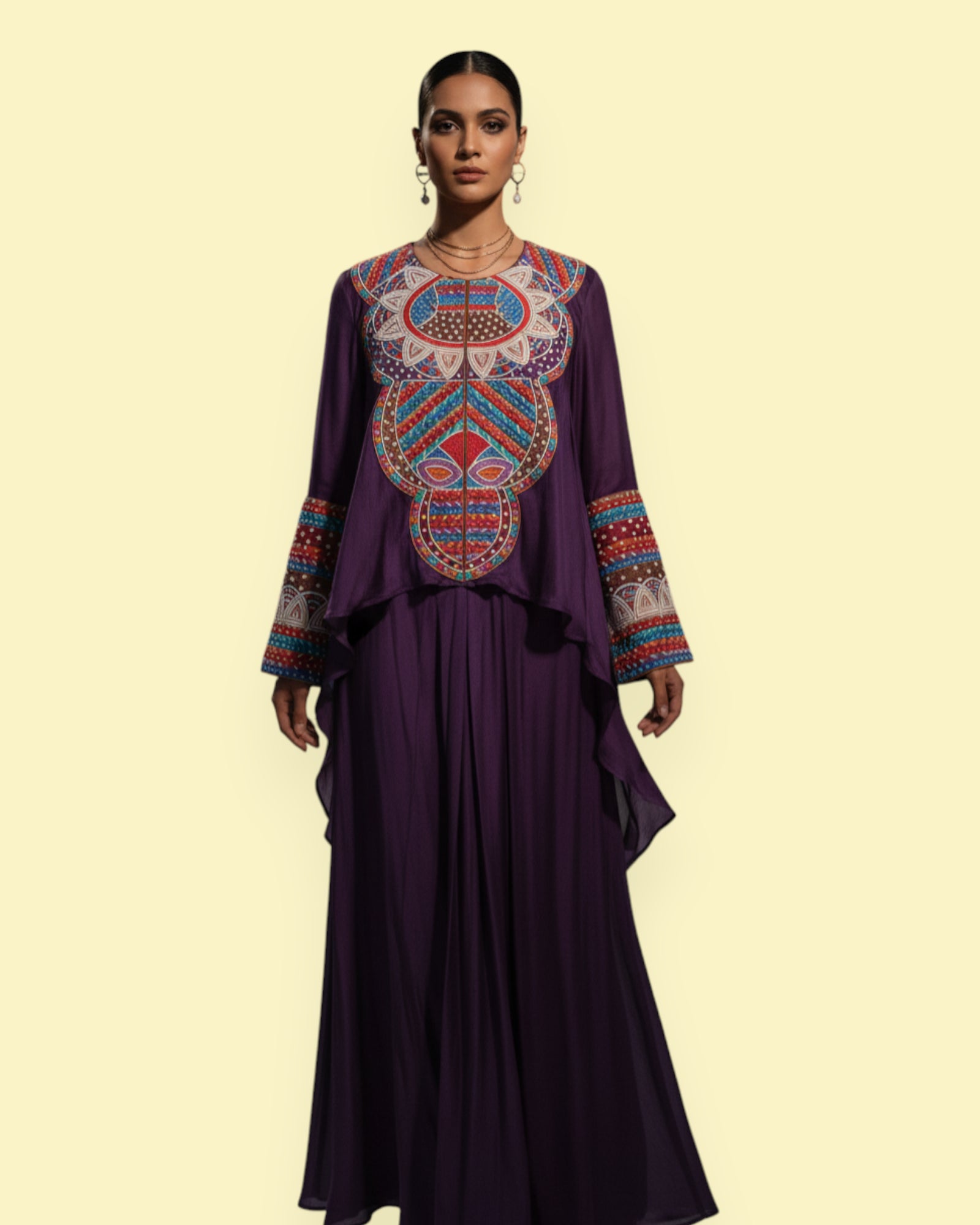 Woman wearing a purple dress with colorful embroidery on a beige background