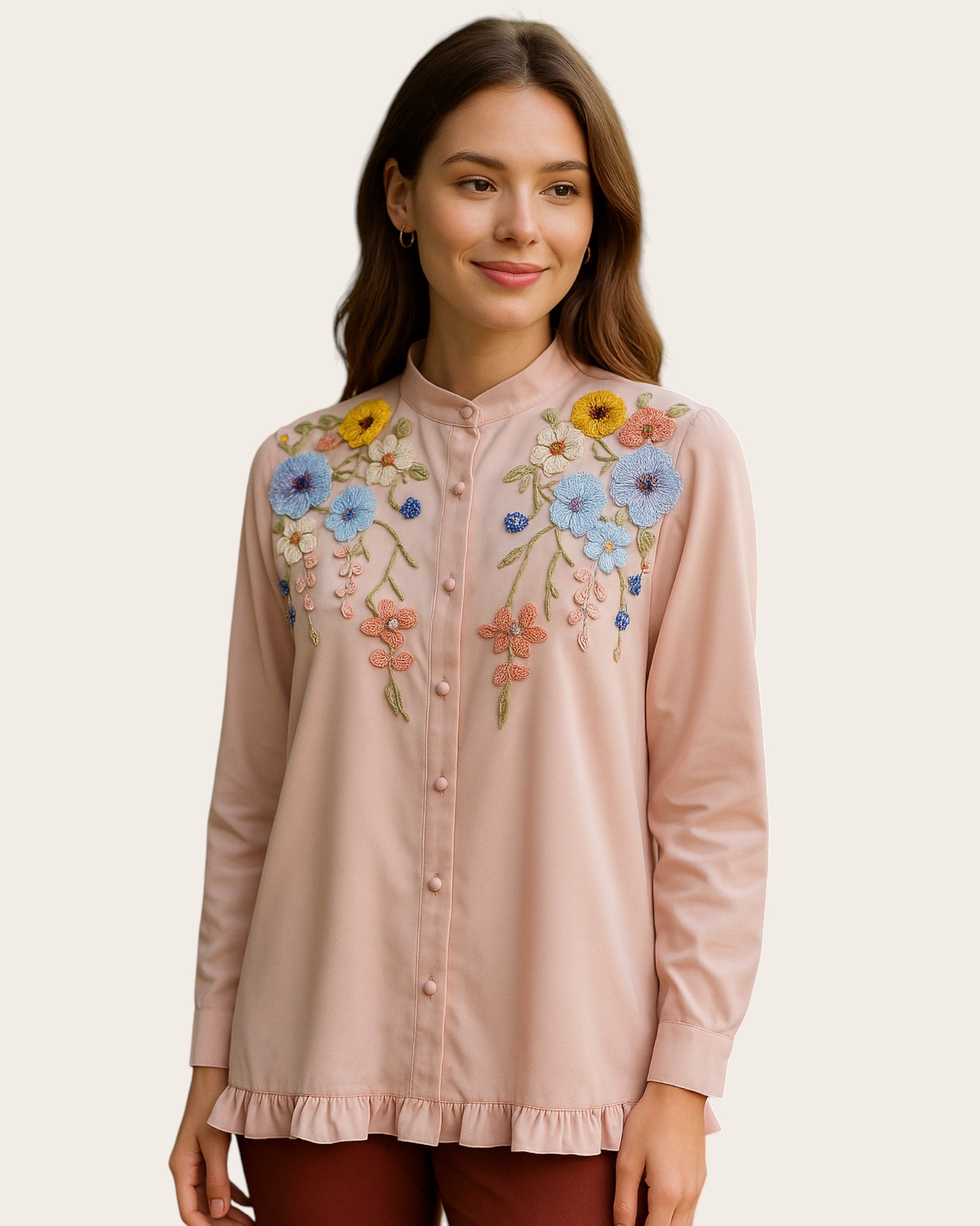 Woman wearing a light pink Shirt with floral embroidery on a beige background