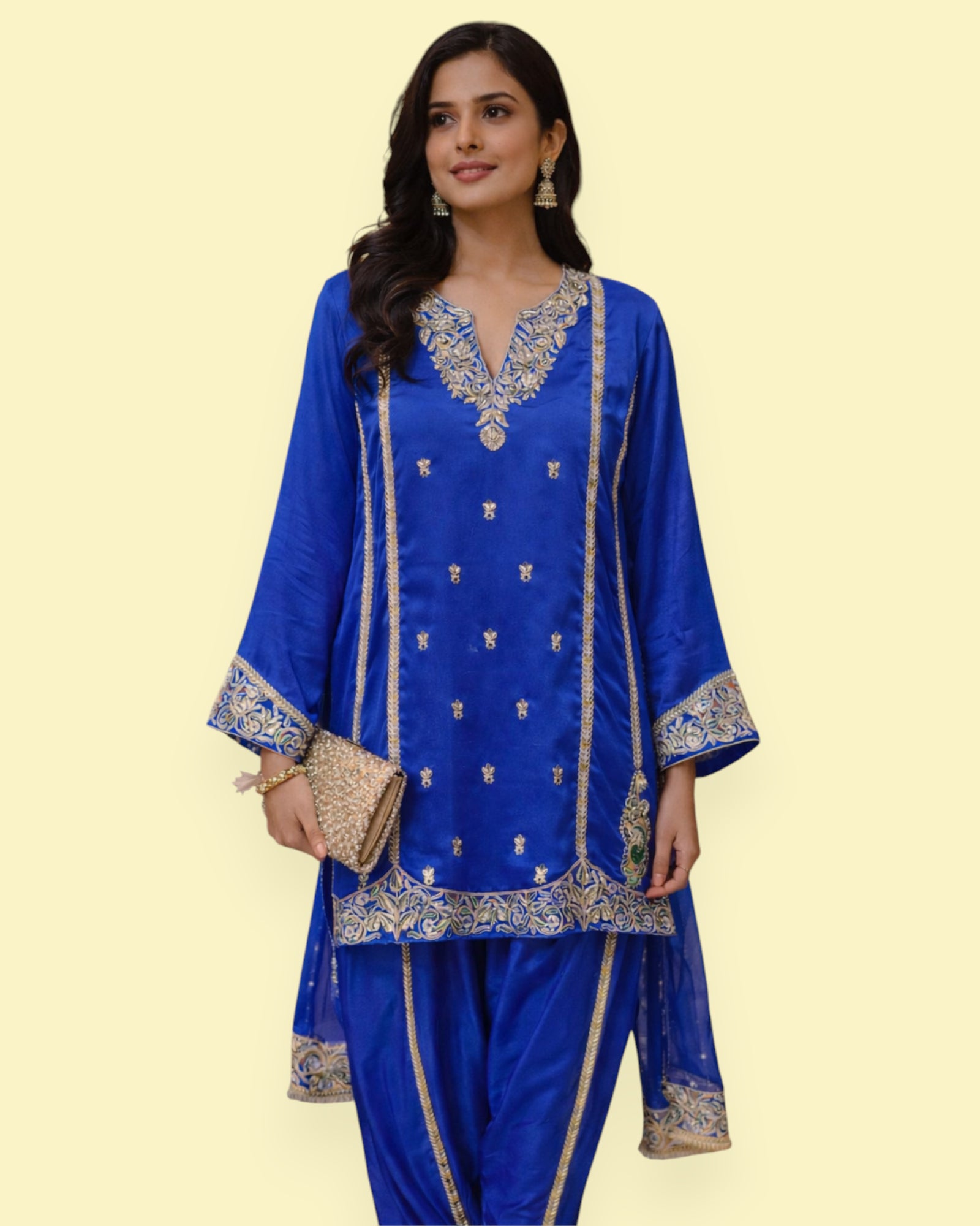 Woman wearing a blue embroidered traditional outfit on a beige background