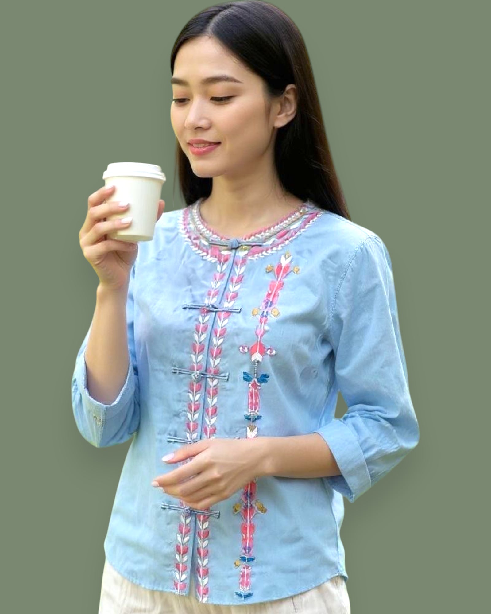 Woman wearing a light blue embroidered Shirt