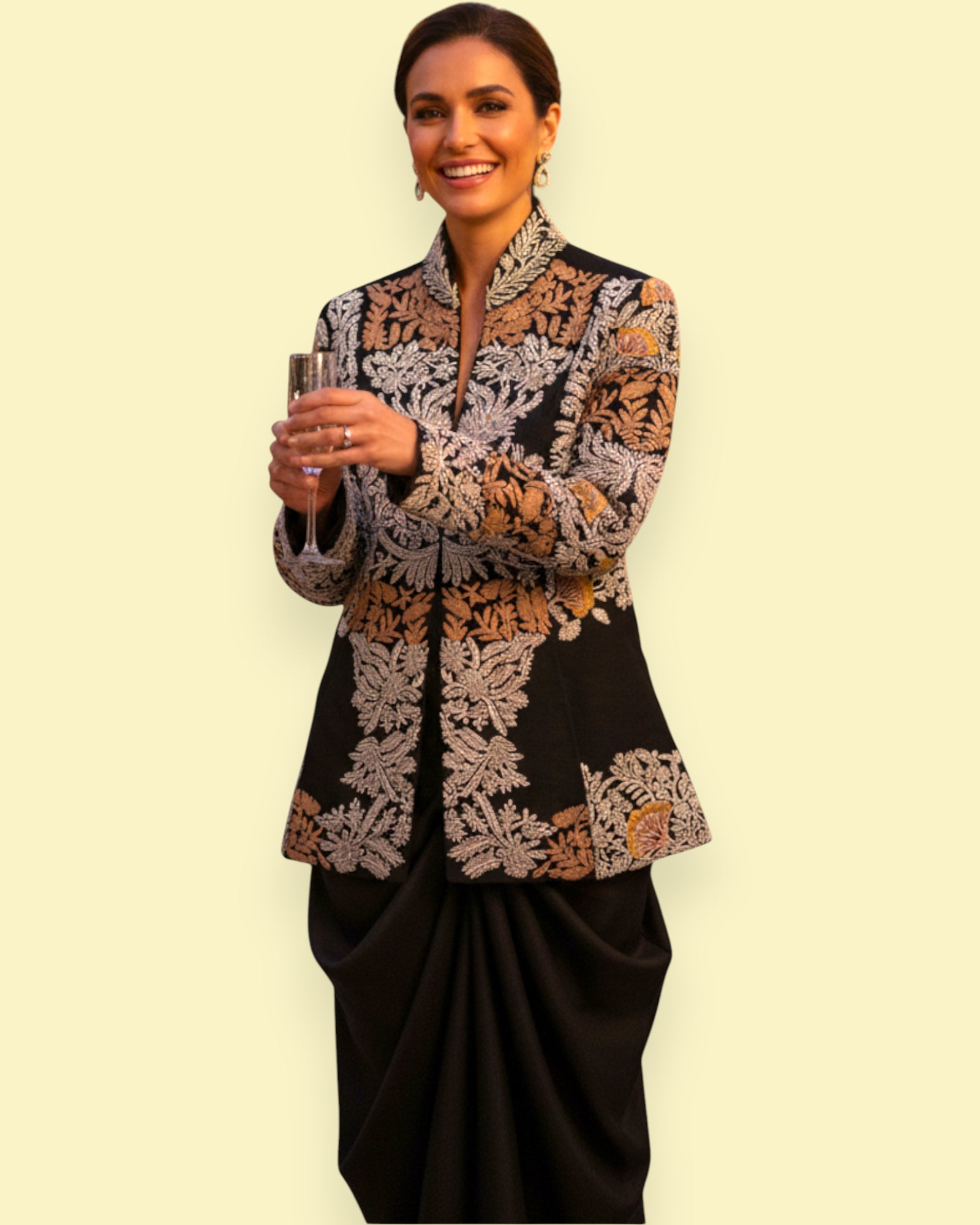 Woman wearing a Embroidery jacket and black pants against a beige background