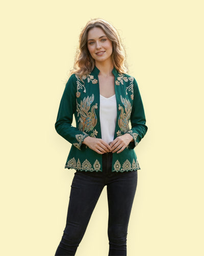 Woman wearing a green embroidered jacket on a yellow background