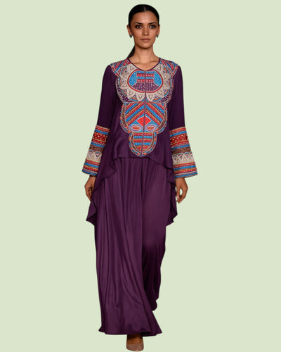 Woman wearing a purple outfit with Colorful embroidery on a light green background