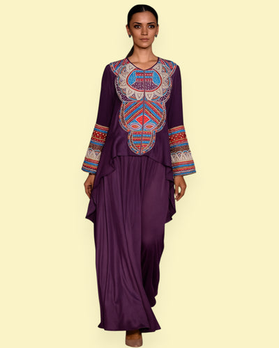 Woman wearing a purple outfit with intricate Embroidery on a light green background