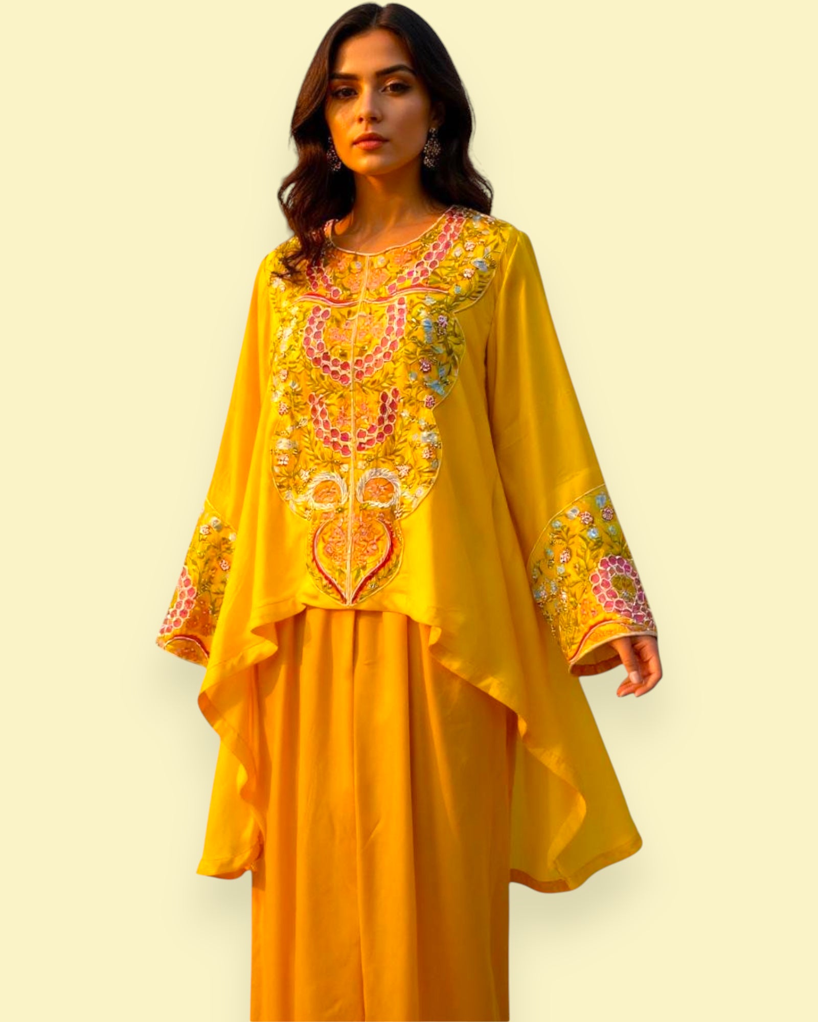 Woman wearing a yellow embroidered outfit on a beige background