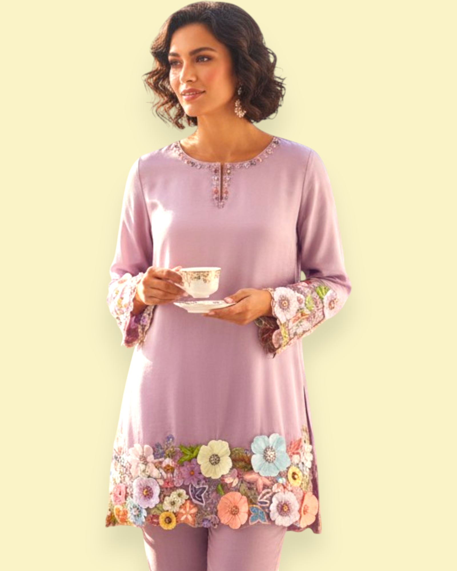 Woman wearing a light purple dress with floral embroidery, holding a teacup against a light yellow background.