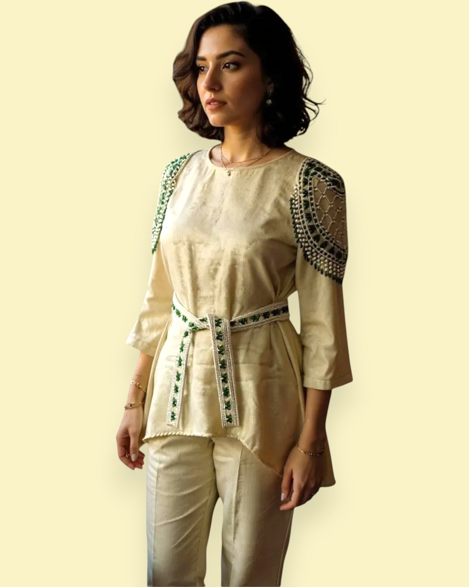 Woman wearing a beige outfit with green accents on a light yellow background