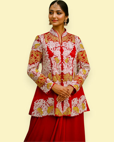 Woman wearing a red and gold embroidered traditional outfit on a beige background