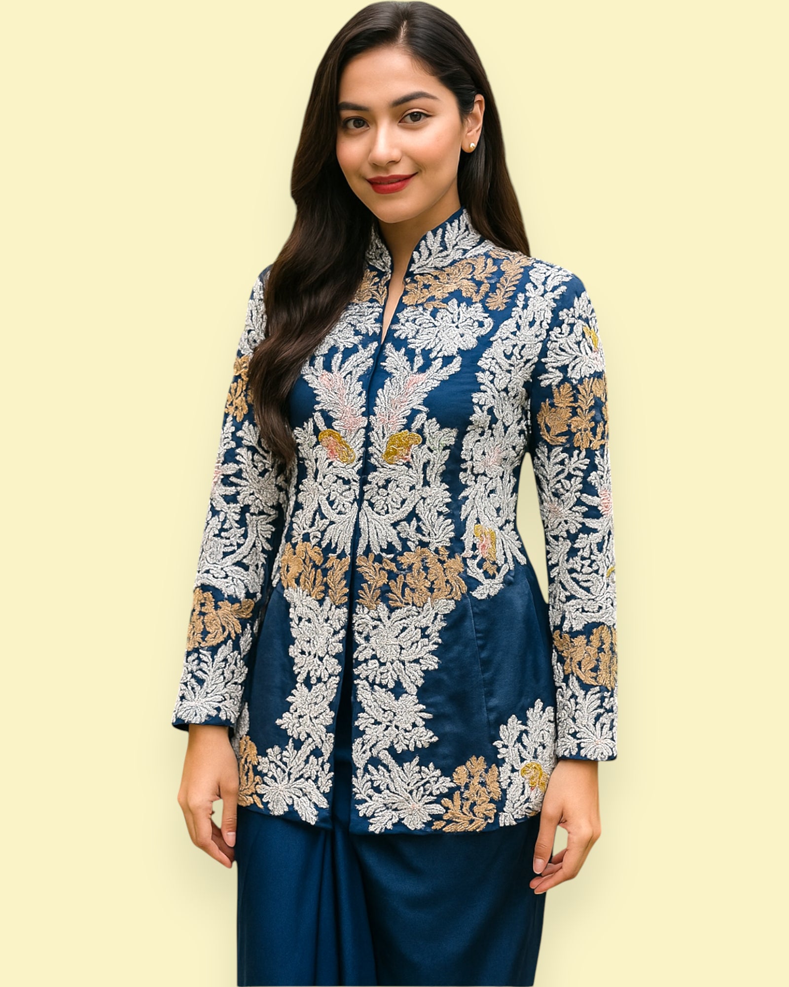 Woman wearing a blue and white floral embroidered Top against a light yellow background
