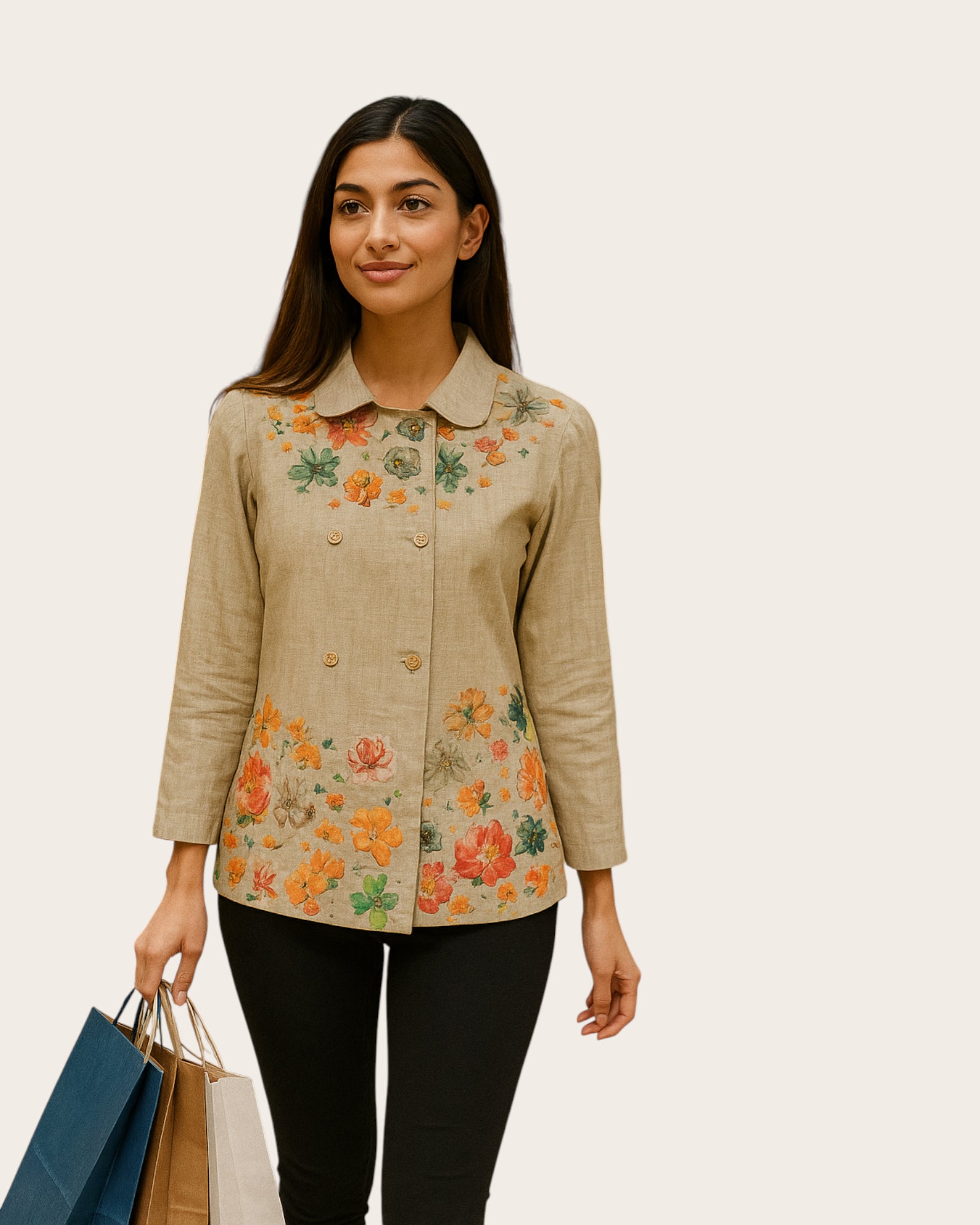 Woman wearing a beige floral jacket against a plain background