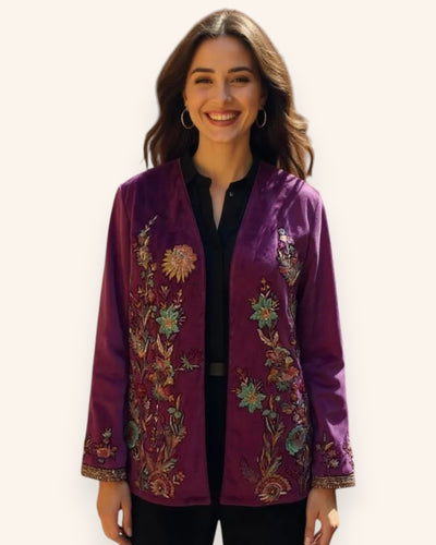 Woman wearing a purple embroidered jacket on a white background