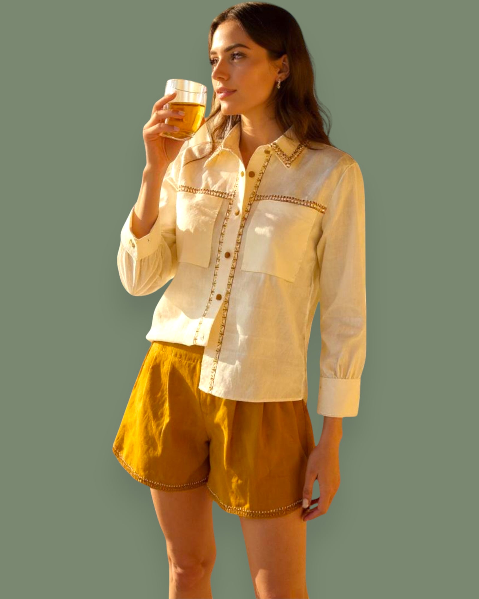 Woman wearing a Beige Linen Shirt and mustard shorts against a plain background