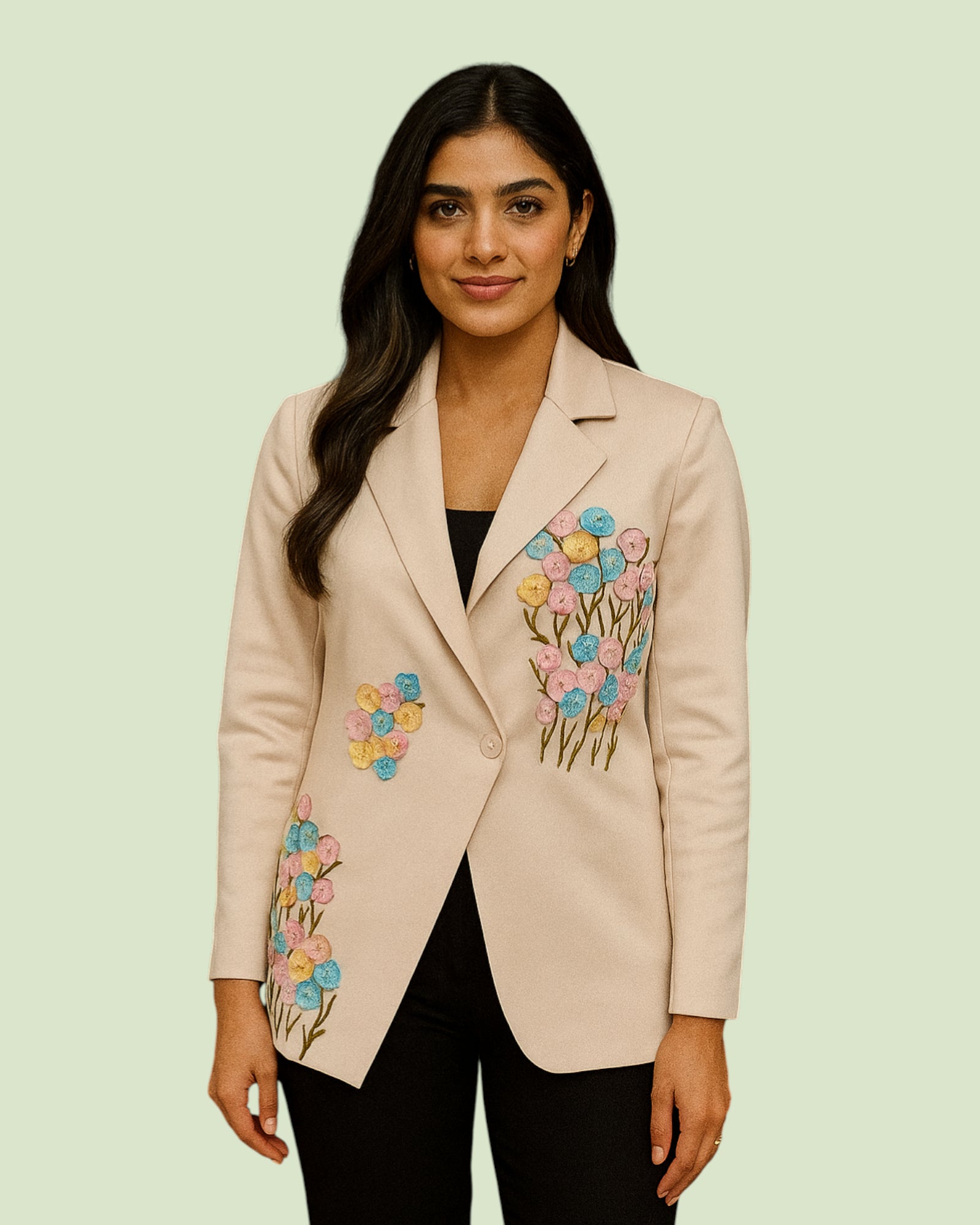Woman wearing a beige blazer with floral embroidery on a light green background