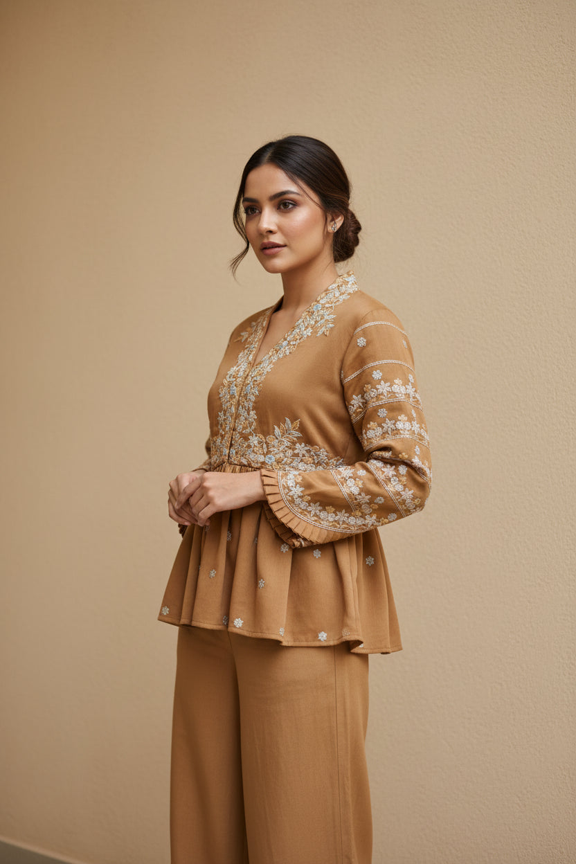 Woman wearing a brown outfit with intricate detailing on a beige background