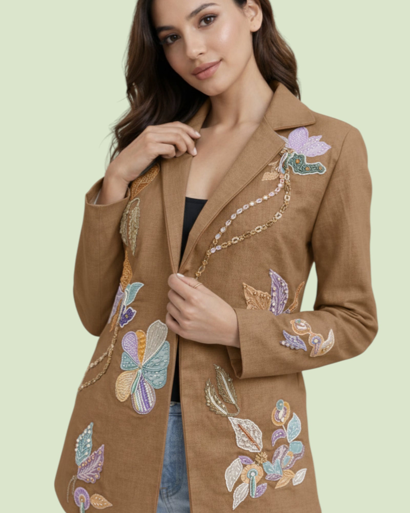 Woman wearing a brown embroidered jacket on a light green background