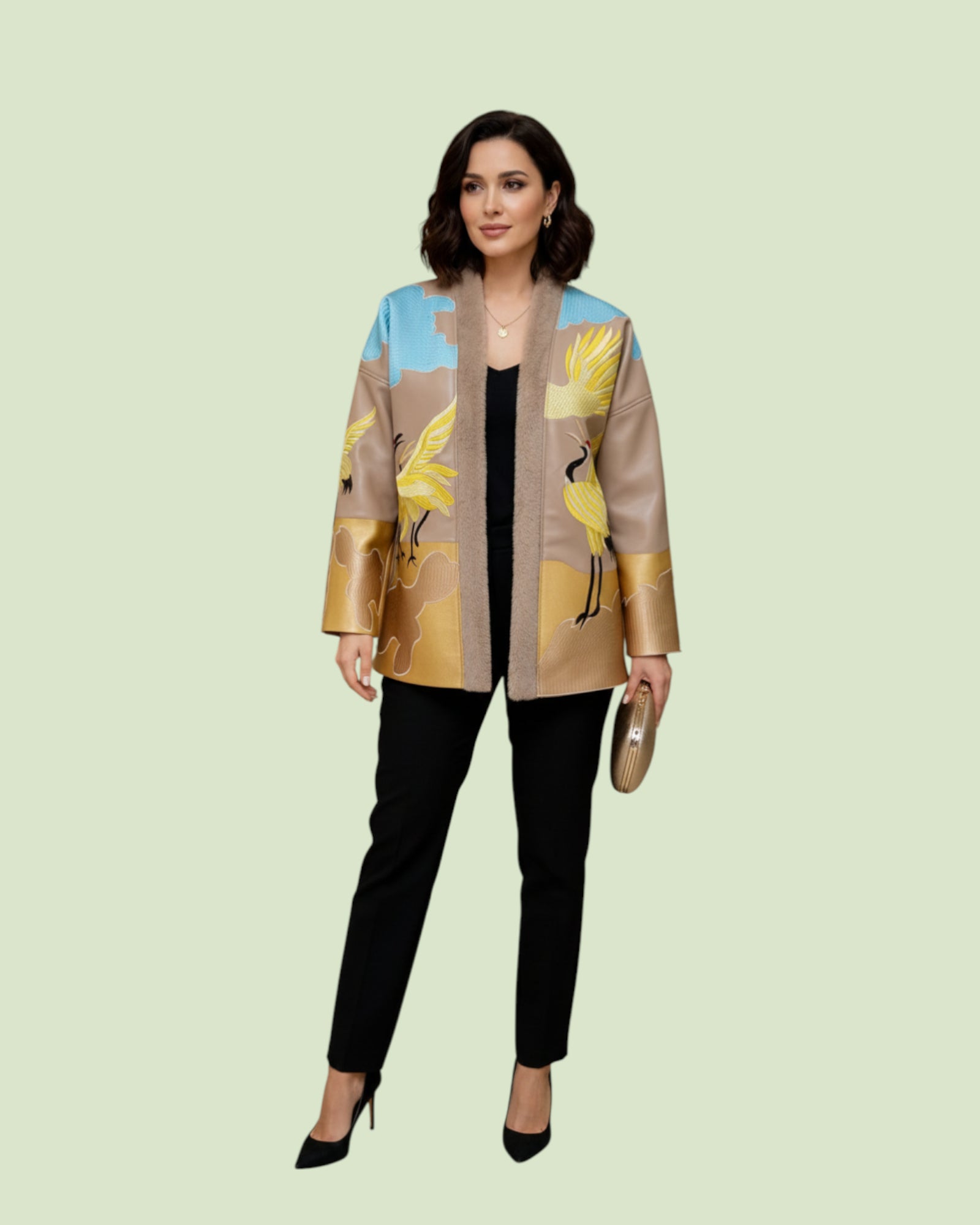 Woman wearing a stylish Embroidery jacket with bird design on a light green background