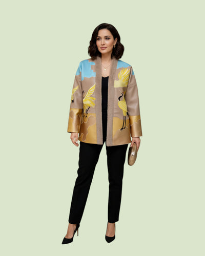 Woman wearing a stylish Embroidery jacket with bird design on a light green background