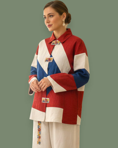 Woman wearing a colorful jacket with geometric embroidery  on a green background