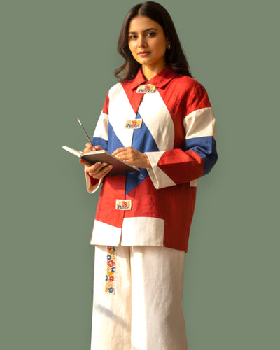 Woman wearing a colorful jacket with a green background