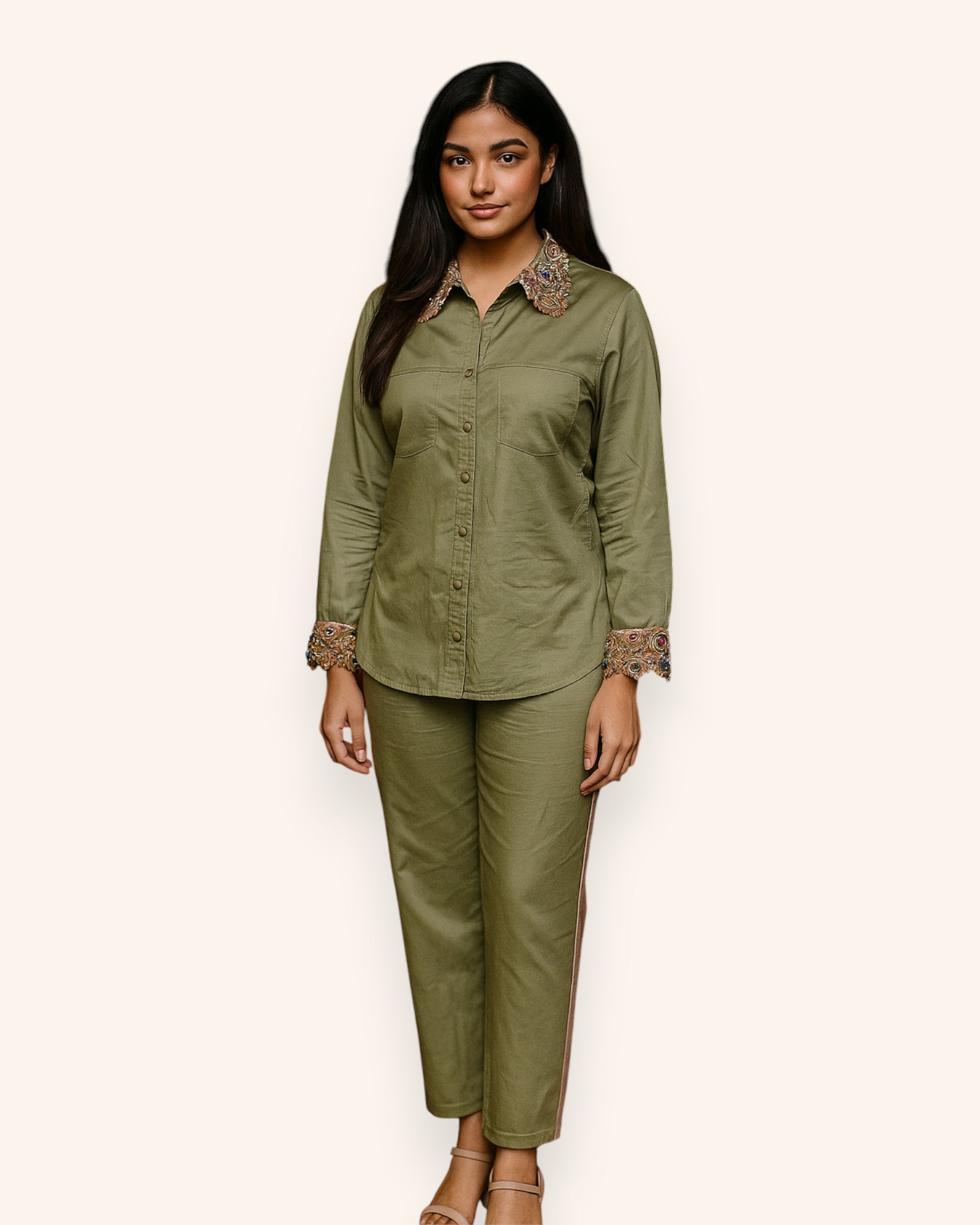 Woman wearing an olive green outfit with lace details on a white background