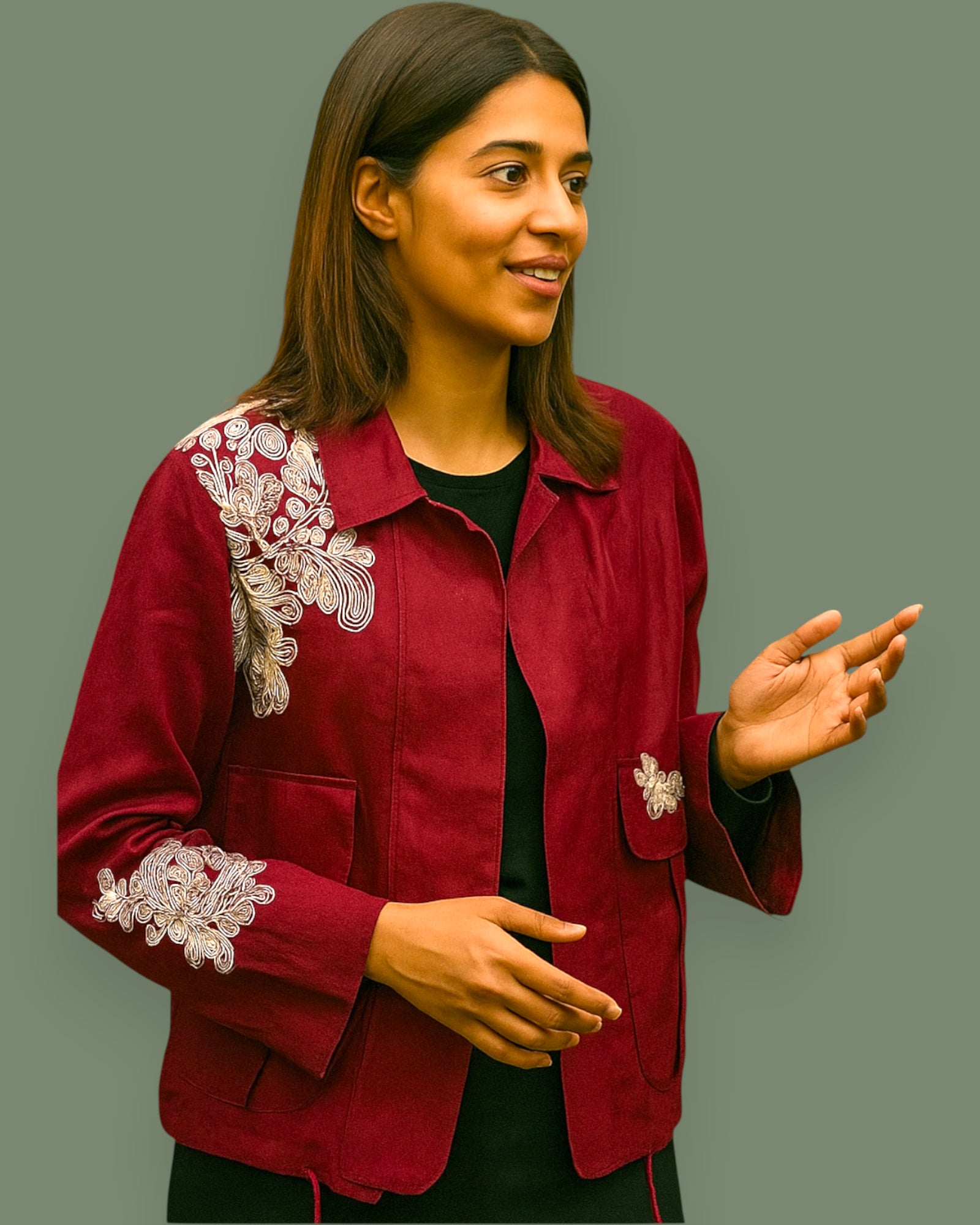 Woman wearing a red jacket with white floral embroidery on a gray background