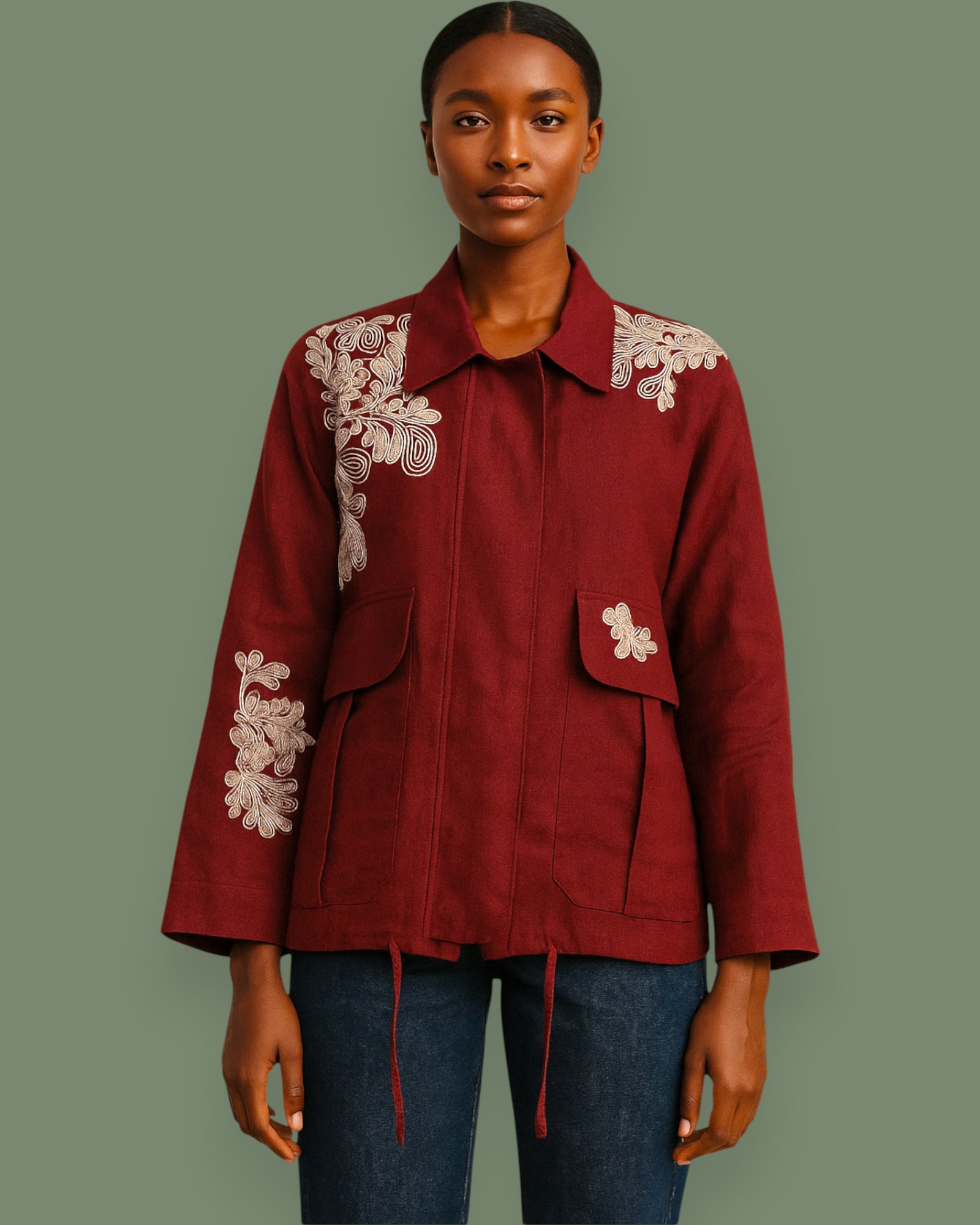 Red jacket with white floral embroidery on a green background