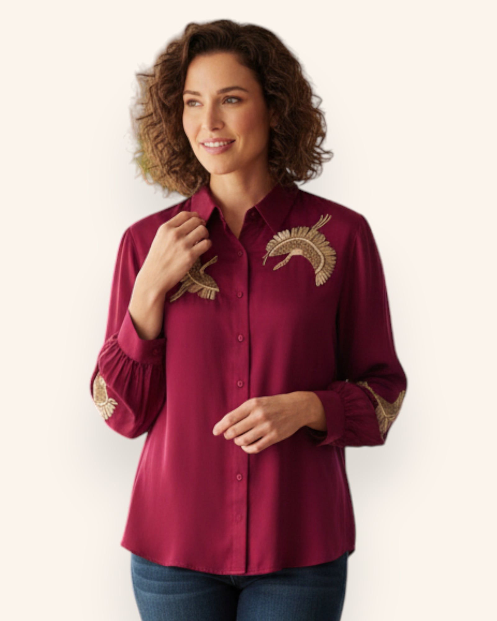 Woman wearing a Red Shirt with gold embroidery on a white background