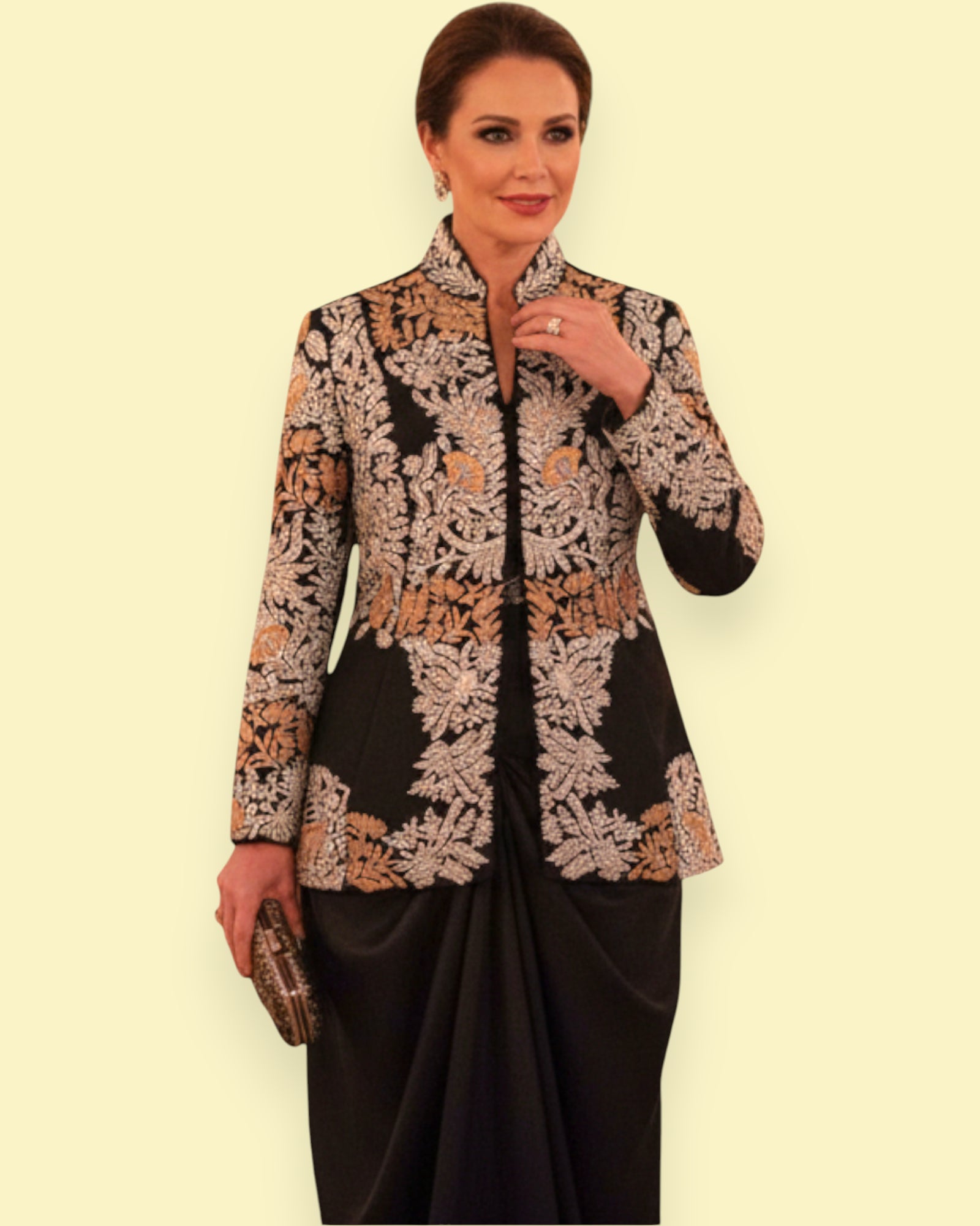 Woman wearing a Embroidery jacket and black skirt against a beige background