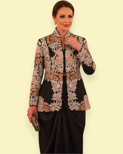Woman wearing a Embroidery jacket and black skirt against a beige background